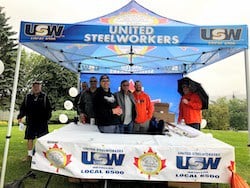 USW Local 6500 members at the local&rsquo;s booth for Sudbury&rsquo;s Labour Day celebrations in 2019. Chris Banks (second from right), promoted a free first aid course for members and their families