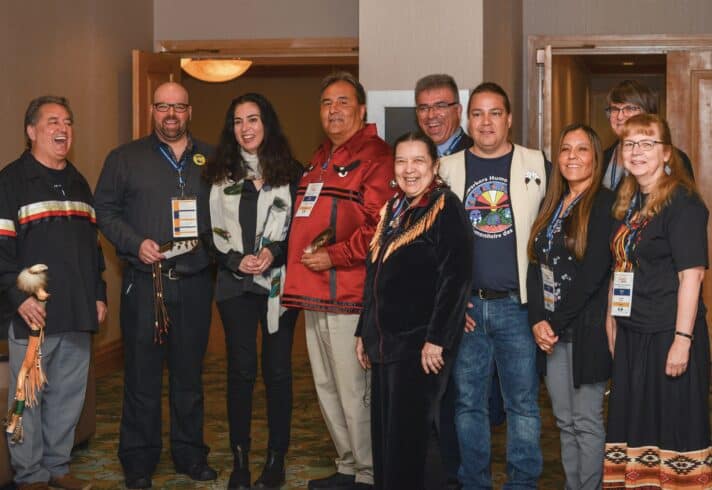 A group picture of Indigenous Steelworkers standing together and smiling.