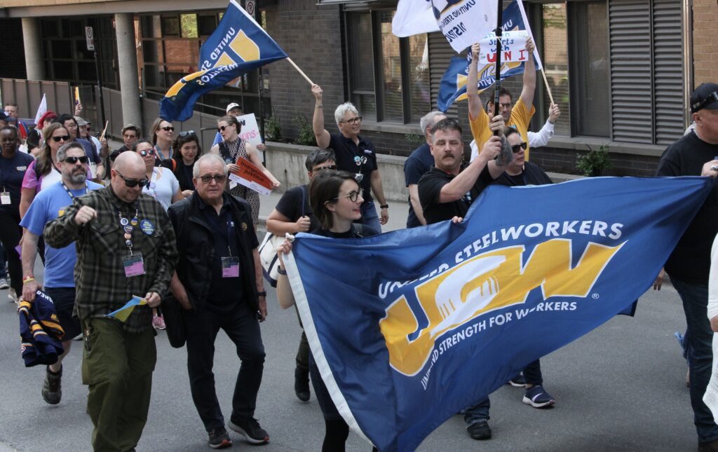 Steelworkers marching in the streets to demand action