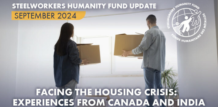 A photo of a couple carrying moving boxes and looking out through the apartment window.