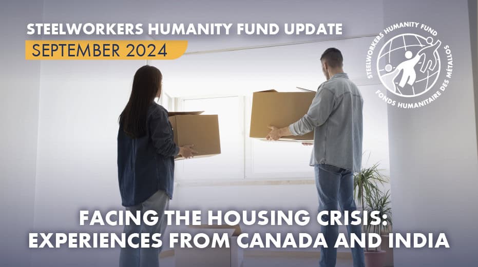 A photo of a couple carrying moving boxes and looking out through the apartment window.