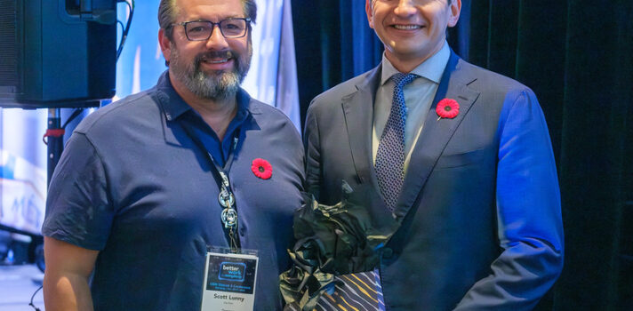 2 men standing on the stage with The red poppy pins