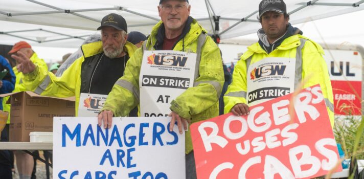 3 people holding signs that read managers are scabs too and Rogers uses scabs