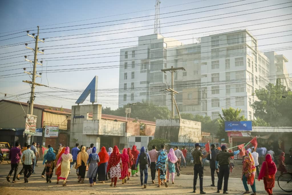 A group of workers walking towards a factor