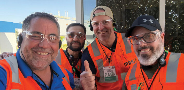 a group of people wearing orange vests