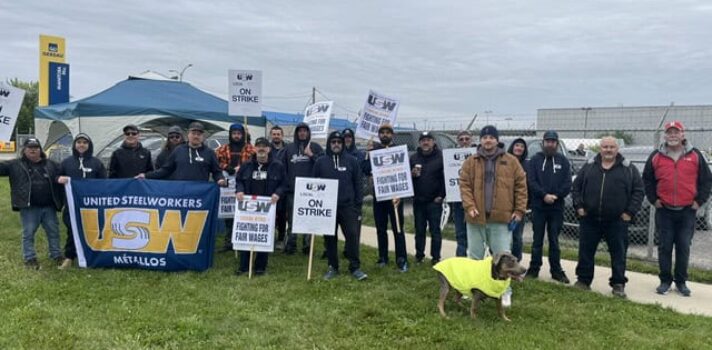 People standing holding picket signs